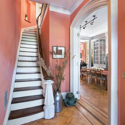 Staircase - small traditional wooden curved wood railing staircase idea in New York with painted risers