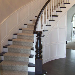 Example of a large classic wooden curved staircase design in Other with painted risers