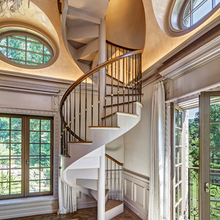 Elegant wooden spiral staircase photo in New York with wooden risers