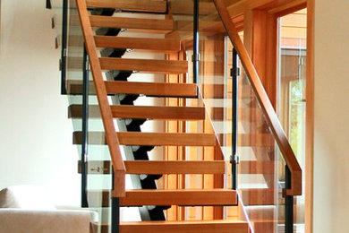 Inspiration for a modern wooden straight open and glass railing staircase remodel in Seattle