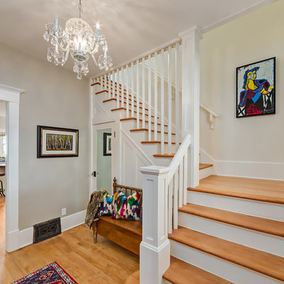 Mid-sized elegant wooden l-shaped staircase photo in Calgary with painted risers