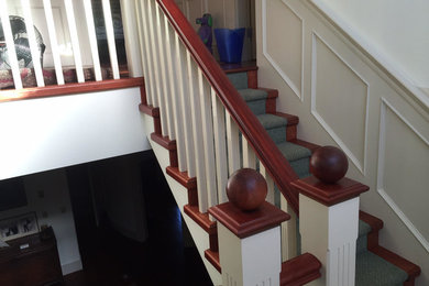 Example of a large classic carpeted u-shaped staircase design in Vancouver with carpeted risers