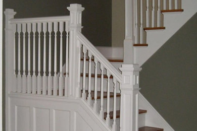 Example of a mid-sized classic wooden u-shaped staircase design in New York with painted risers