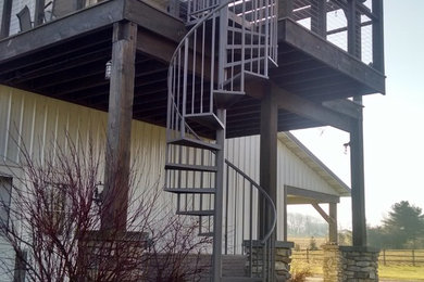 Example of a mid-sized mountain style staircase design in Cleveland