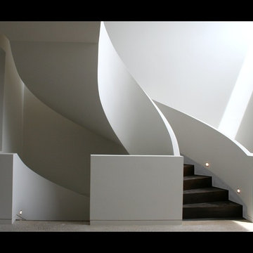 Geometric curved stair with curved dwarf wall balustrade