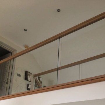 Glass balustrade with oak rails and white stringers