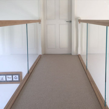 Glass balustrade with oak rails and white stringers