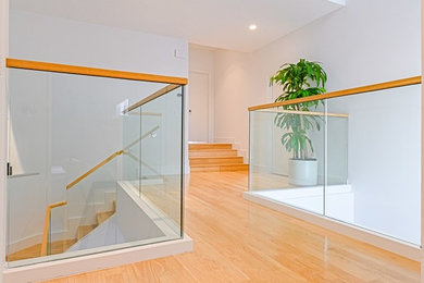 Design ideas for a medium sized modern l-shaped glass railing staircase in Tampa.