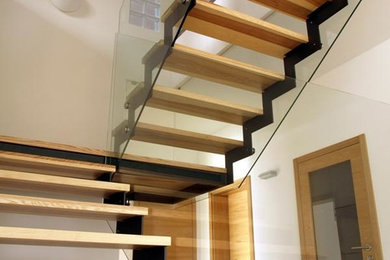 Design ideas for a modern wood l-shaped staircase in Other with open risers.