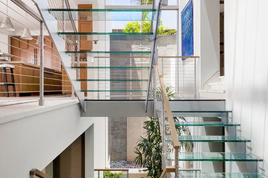 Example of a large trendy glass open staircase design in Los Angeles