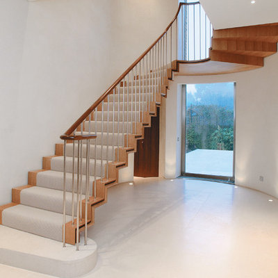 Trendy wooden u-shaped staircase photo in London with wooden risers