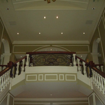 Grand staircase in foyer leading to grand double story great room.
