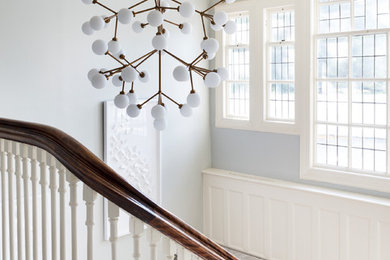 Large trendy carpeted u-shaped wood railing staircase photo in New York with carpeted risers