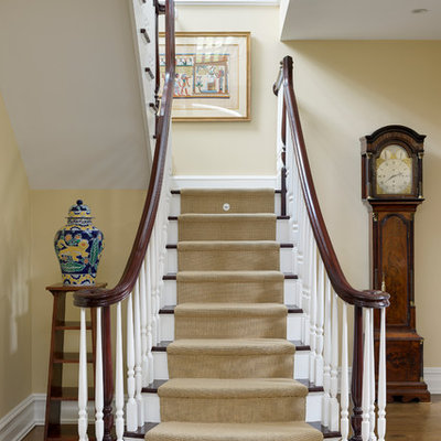 Mid-sized elegant wooden u-shaped staircase photo in New York with painted risers