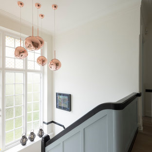 Design ideas for a large classic carpeted wood railing staircase in London.