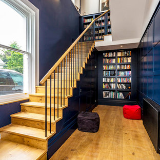 Design ideas for a large classic wood straight wood railing staircase in Surrey with wood risers.