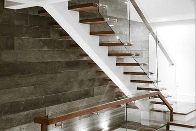 Medium sized contemporary wood l-shaped staircase in Toronto with open risers.