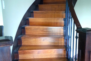 Staircase - large contemporary wooden curved wood railing staircase idea in Vancouver with wooden risers