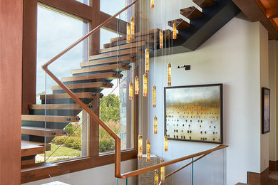 Large contemporary wood floating staircase in Baltimore with open risers.