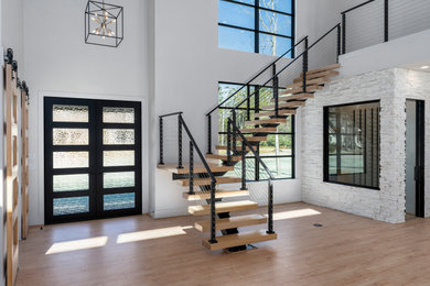 Inspiration for a huge modern wooden floating open and cable railing staircase remodel in Houston