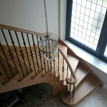Small curved Helical Staircase in American White Oak with Wrought Iron balustrad
