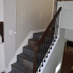 Imagen de escalera en L, clásica, pequeña, con escalones con baldosas, contrahuellas con baldosas y/o azulejos y barandilla de madera