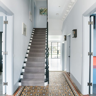 Victorian wood straight wood railing staircase in London with wood risers.