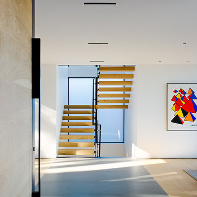 Inspiration for a modern wooden u-shaped open and mixed material railing staircase remodel in San Francisco
