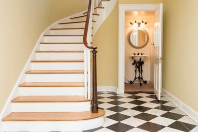 Design ideas for a large traditional wood curved wood railing staircase in Baltimore with painted wood risers.