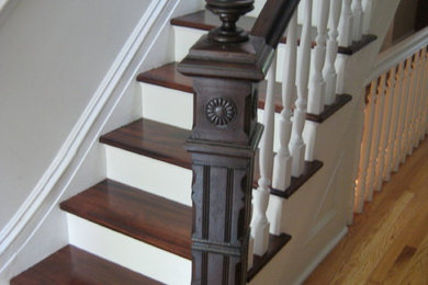 Mid-sized elegant wooden straight staircase photo in New York with painted risers