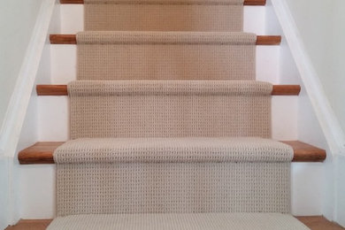 Carpeted straight staircase in Other.
