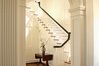 Example of a large classic wooden u-shaped staircase design in Atlanta with painted risers