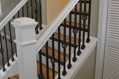 Inspiration for a mid-sized timeless wooden straight wood railing staircase remodel in Other with painted risers