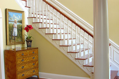 Staircase - mid-sized traditional wooden curved wood railing staircase idea in Miami with wooden risers