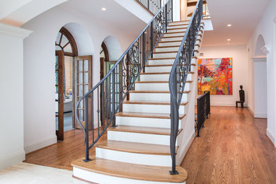 Large transitional wooden straight metal railing staircase photo in Cincinnati with painted risers