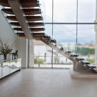 Example of a mid-sized minimalist painted l-shaped open and glass railing staircase design in Los Angeles