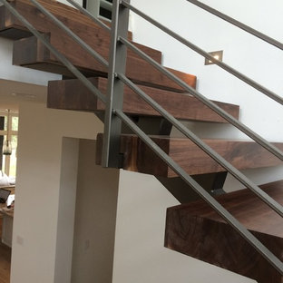 Inspiration for a mid-sized industrial wooden floating staircase remodel in Austin with wooden risers