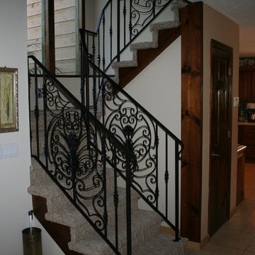 Interior custom ornamental iron stair rail with custom design panels