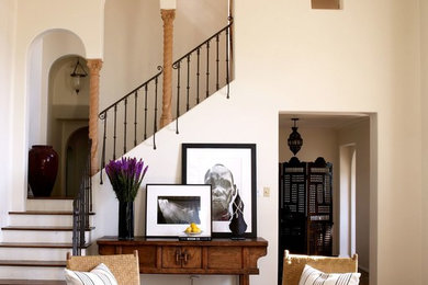 Tuscan wooden l-shaped metal railing staircase photo in Los Angeles with wooden risers