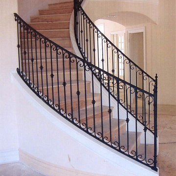 Interior wrought iron stair rails with newel posts, baluster collars, twisted pi