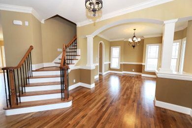Example of a mid-sized wooden curved staircase design in Oklahoma City with painted risers