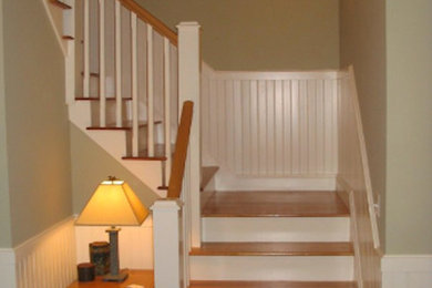 Example of a trendy wooden l-shaped staircase design in Portland Maine with painted risers