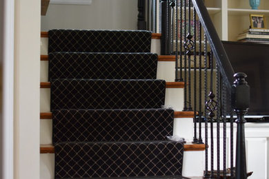 Ejemplo de escalera en L tradicional de tamaño medio con escalones de madera, contrahuellas de madera pintada y barandilla de metal