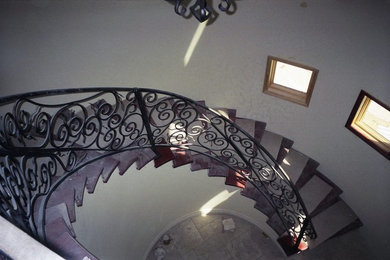 Inspiration for a large mediterranean wood spiral staircase in Phoenix with wood risers.