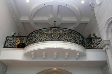 Large elegant wooden curved staircase photo in Chicago with wooden risers