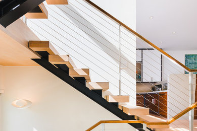 Inspiration for a contemporary wooden u-shaped open and metal railing staircase remodel in San Francisco