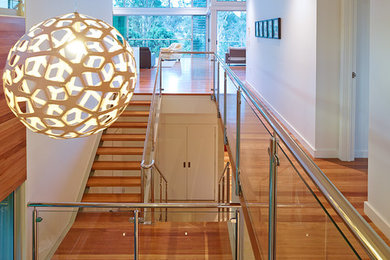 Photo of a contemporary wood u-shaped staircase in Brisbane with metal risers.