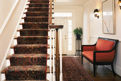 Example of a mid-sized classic wooden straight staircase design in St Louis with painted risers