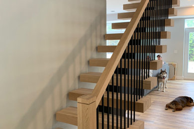 Example of a trendy wooden straight open and mixed material railing staircase design in Toronto