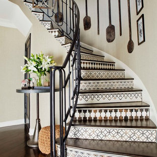 Photo of a mediterranean curved staircase in Los Angeles with tiled risers.